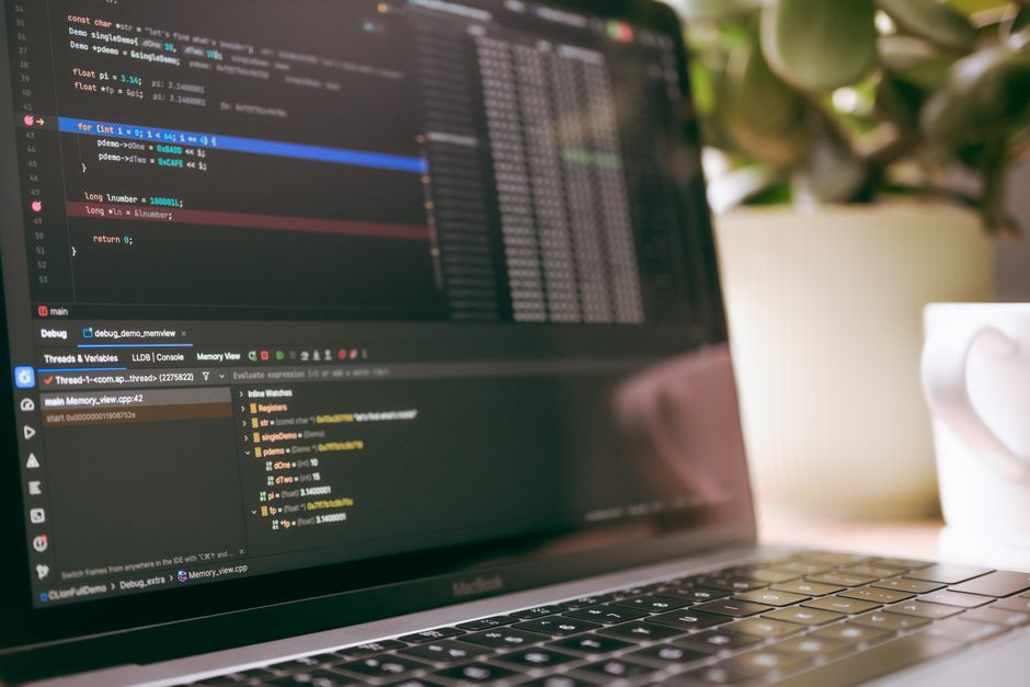 A laptop screen showing programming code and debugging tools, ideal for tech topics.